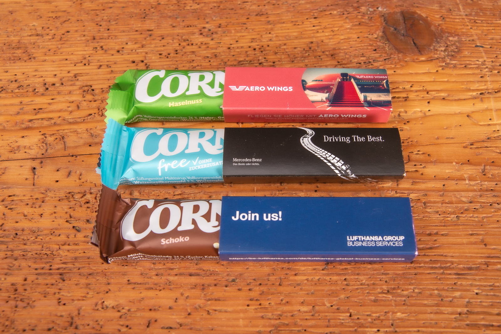 Corny M&uuml;sliriegel im bedruckten Werbeschuber als g&uuml;nstiger Streuartikel f&uuml;r Messen und Seminare