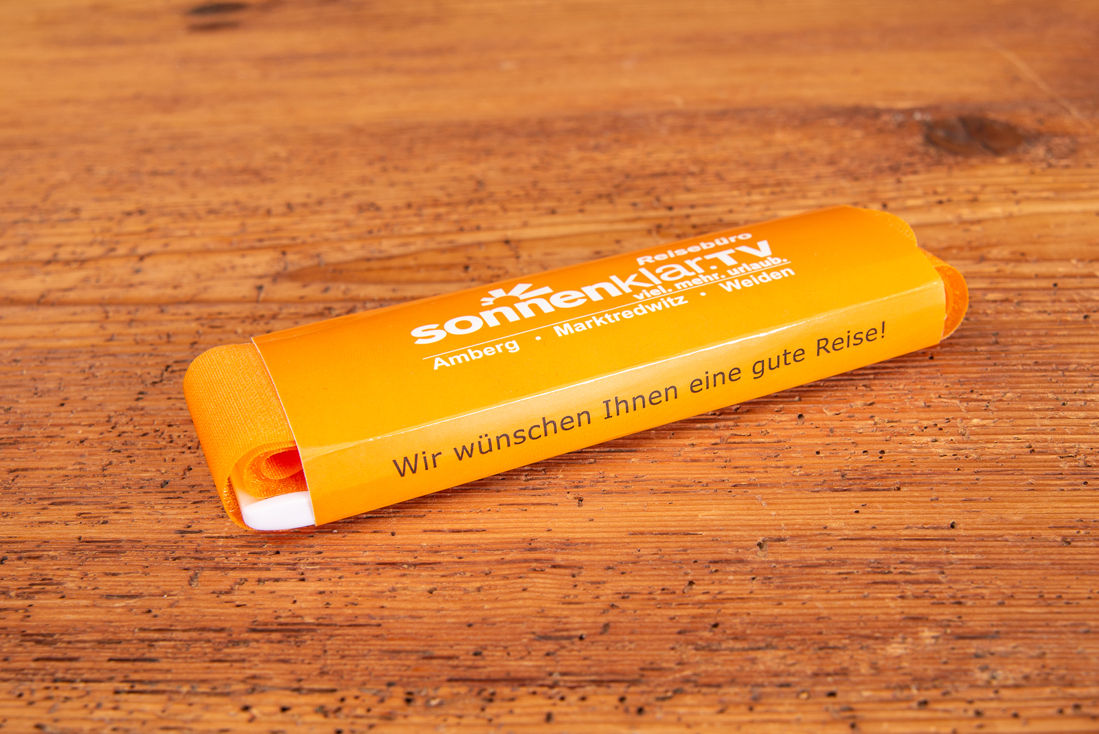 Koffergurt Speedstrap orange mit individuell bedruckter Werbebanderole.