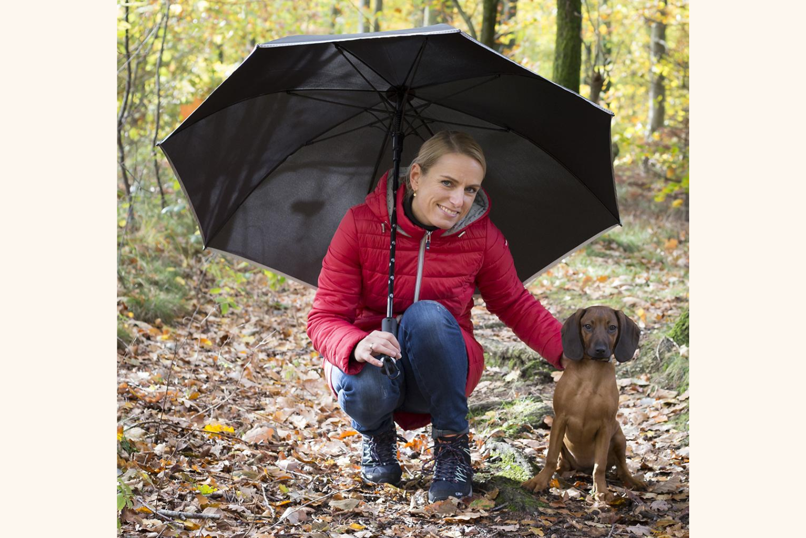 Hundebesitzerin mit Hund und FARE Doggybrella Stockschirm als Werbeartikel.