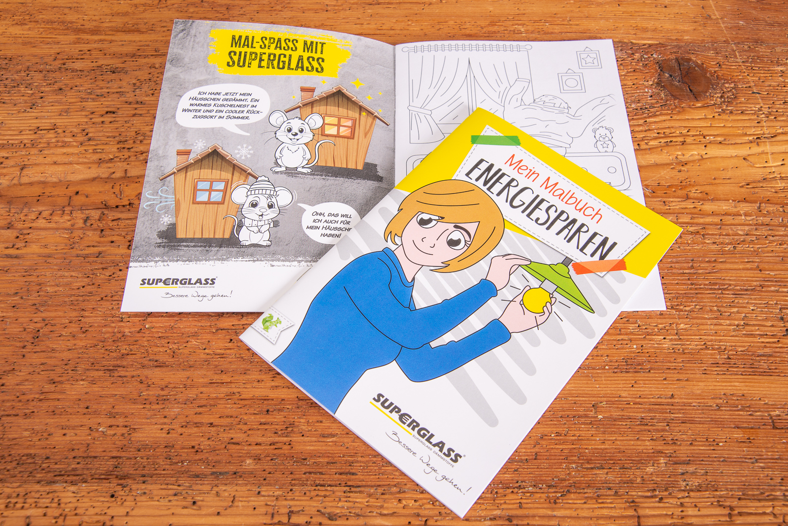 Individuelles Malbuch DIN A5 mit Logo als Werbeartikel ein Beispiel f&uuml;r bedrucktes Kindermalbuch mit 12 Seiten auf Holztisch.