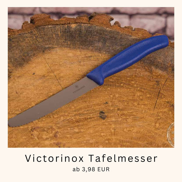 victorinox tafelmesser mit blauem griff auf Schneidebrett aus Holz