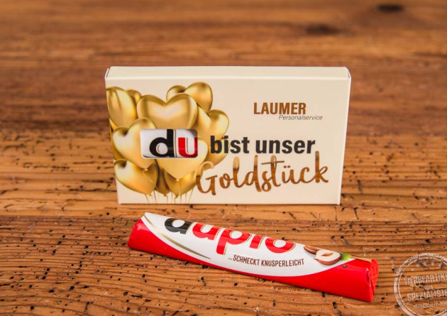 Duplo Schokoriegel im individuell bedruckten Werbeschuber mit der Aufschrift „Du bist unser Goldstück“ und goldenem Herzdesign – ideal als emotionales Give-away für Mitarbeiter und Kunden.