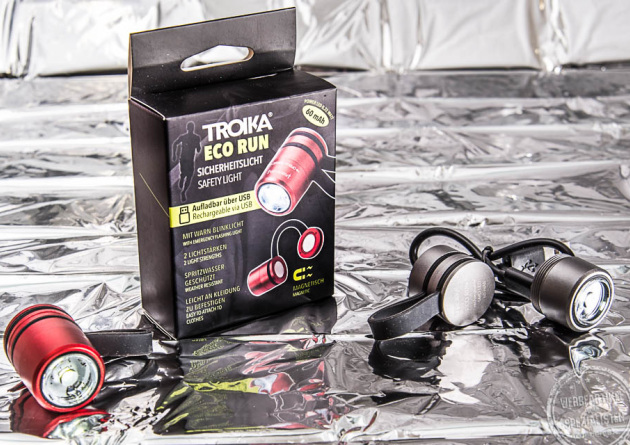 Mini Sicherheitslicht ECO RUN als Werbeartikel mit Logo mit Verpackung auf silberner Folie.