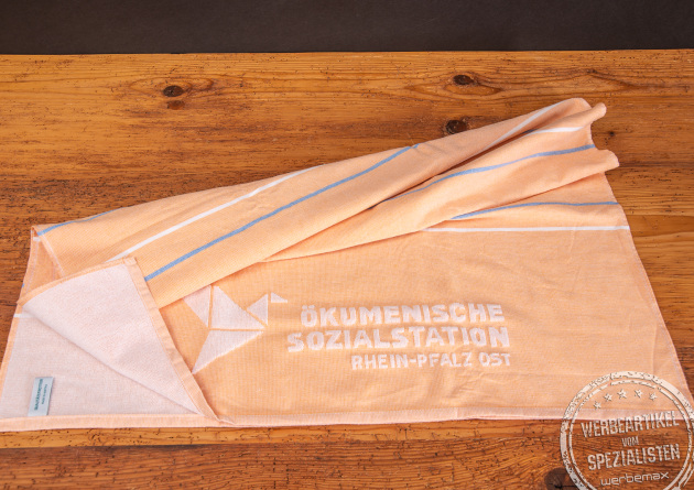Strandtuch orange mit Einwebung als Werbeartikel.
