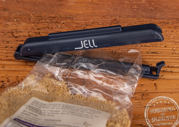 T&uuml;tenclips als langlebige und g&uuml;nstige Werbeartikel. Hier ein JELL T&uuml;tenclip DACLIPA in schwarz mit wei&szlig;em Logo