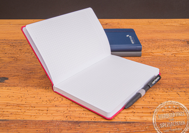 Aufgeschlagenes Notizbuch mit Stifteschlaufe und Mikroperforation. So k&ouml;nnen die Notizen einfach weitergegeben oder abgeheftet werden. Das universelle Winkelkaro ist f&uuml;r deutsche Kunden oder Mitarbeiter perfekt. 