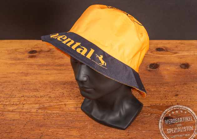 Gelb-schwarzer Continental Bucket Hat auf Modelkopf, vollfl&auml;chig bedruckter Fischerhut als aufmerksamkeitsstarkes Werbegeschenk f&uuml;r Events und Promotion.