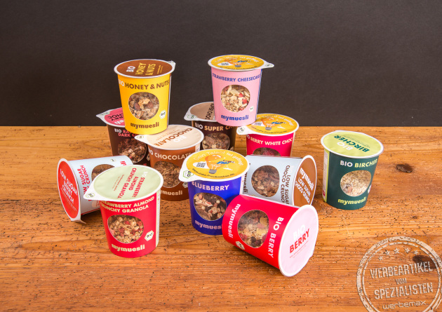 Vielfältiges mymuesli Sortiment – bunte Auswahl an Müsli to go Bechern als Werbeartikel.