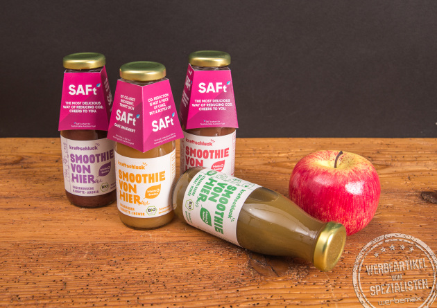 Kraftschluck Smoothie Flaschen mit pinker Werbebanderole und Apfel &ndash; Bio Smoothie als Werbegeschenk mit Logo f&uuml;r Messen und Events