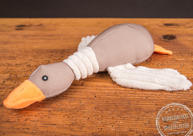 Hundespielzeug mit Quietschfunktion. Das Kauspielzeug in Form einer liegenden Ente kann mit Logo personalisiert werden.