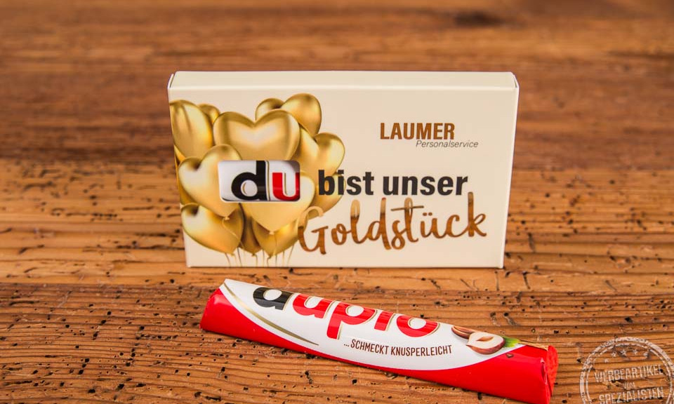 Duplo Schokoriegel im individuell bedruckten Werbeschuber mit der Aufschrift „Du bist unser Goldstück“ und goldenem Herzdesign – ideal als emotionales Give-away für Mitarbeiter und Kunden.