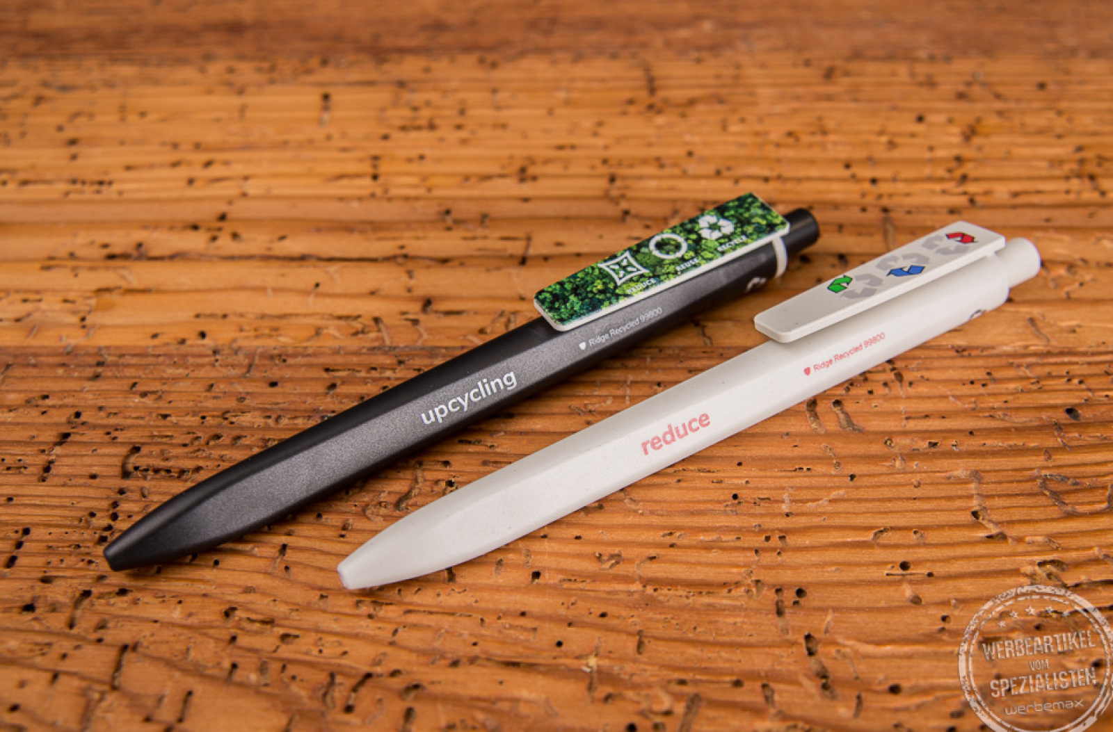 Ein schwarzer und ein weißer nachhaltiger Kugelschreiber von Ritter Pen mit Logoaufdruck auf dem Clip. 