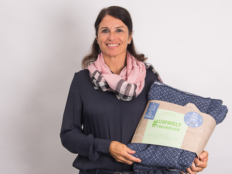 Manager Online-Marketing Britta Unterreitmeier mit Kuscheldecke in der Hand.