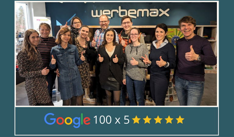 werbemax Team im Showroom mit glücklichen Gesichtern und Daumen hoch.