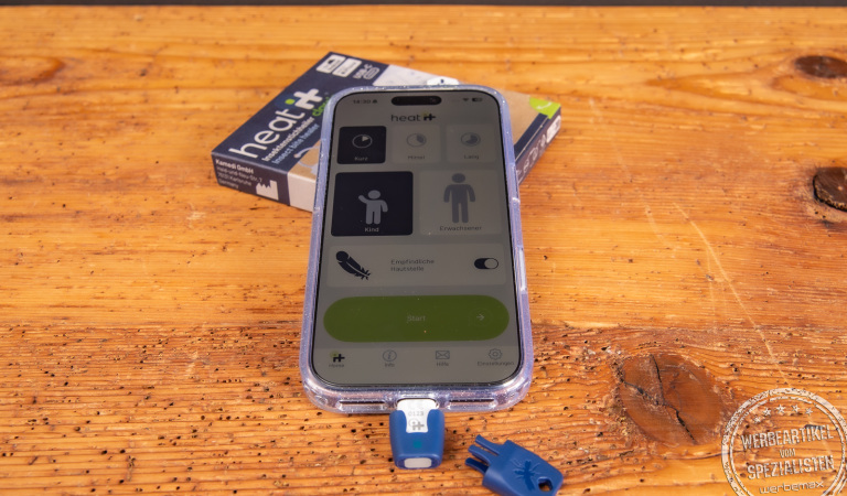 heat it Insektenstichheiler mit Smartphone und Verpackung – chemiefreier Werbeartikel gegen Mückenstiche, ideal für Sommer und Outdoor.