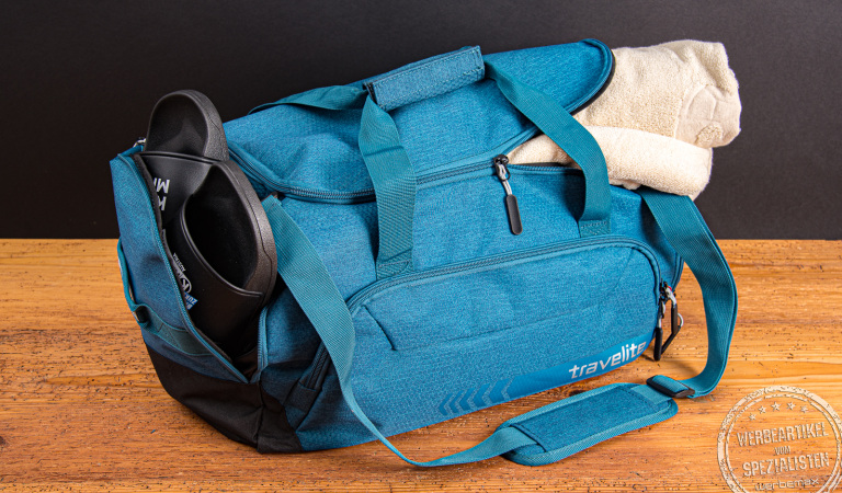 Travelite Kick Off Reisetasche M gepackt mit Handtuch und Badelatschen – ideale Sport- und Freizeittasche für Kurzreisen oder Fitnessstudio.