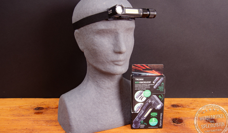 TROIKA ECO Knicklicht mit Verpackung und Stirnband – LED-Stirnlampe und Taschenlampe in einem, mit 5 Lichtmodi und Gravurfläche für Logos als Werbeartikel.