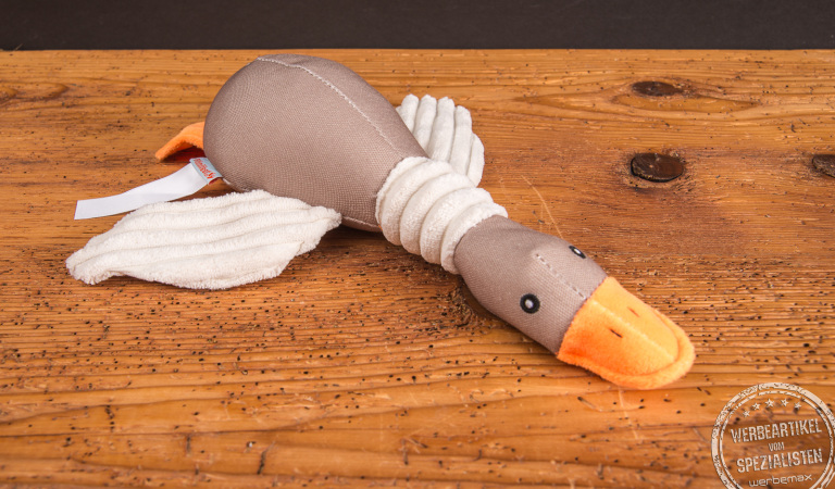 Hundespielzeug Ente aus robustem Material, liegend. Merch f&uuml;r Hundehalter und Hunde mit Logo bedruckbar.